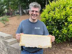Picture of Chris, the local beekeeper holding a frame of honeycomb.  Double Bee Honey, LLC in Suwanee, Georgia 30024. 