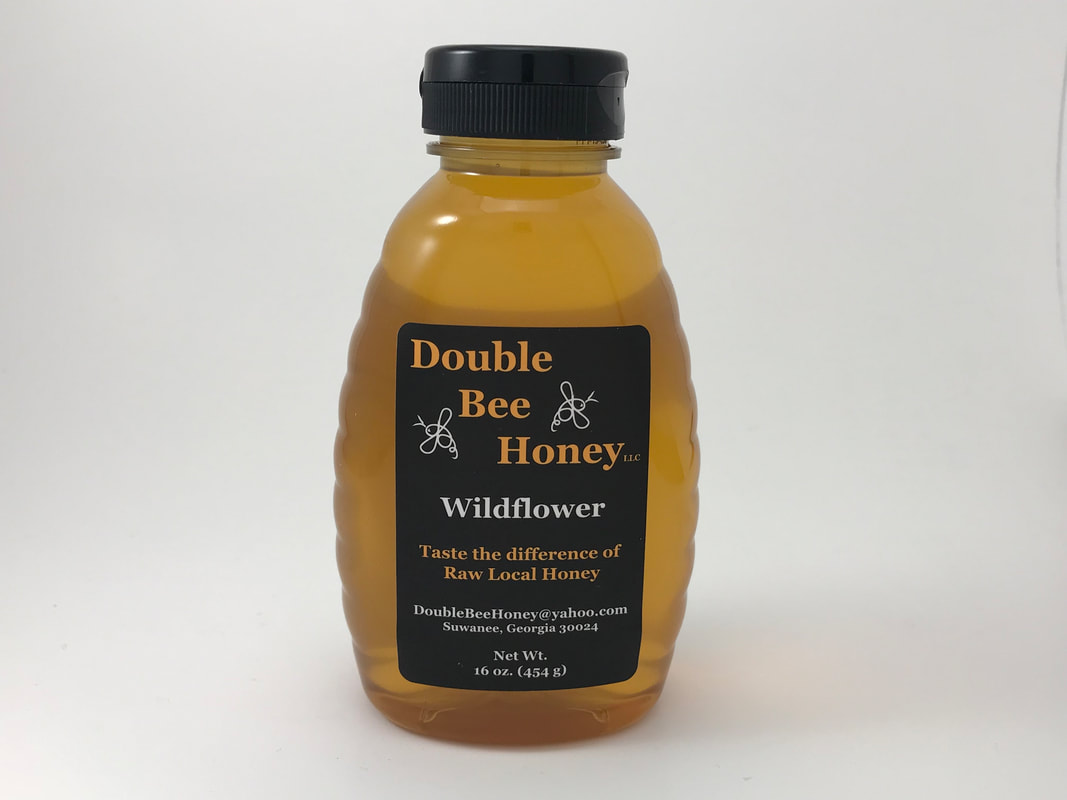 Picture of fresh, raw wildflower honey in a glass bottle by Double Bee Honey, LLC in Suwanee, Georgia. 